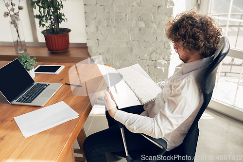 Image of Caucasian young man in business attire working in office, job, online studying