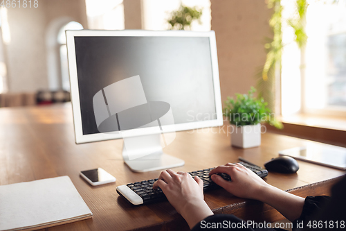 Image of Caucasian young woman in business attire working in office