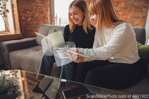 Image of Young friends, women using gadgets to watch cinema, photos, online courses, taking selfie or vlog