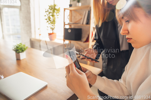 Image of Young friends, women using gadgets to watch cinema, photos, online courses, taking selfie or vlog