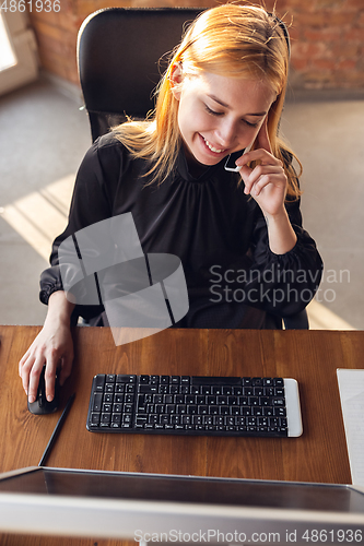 Image of Caucasian young woman in business attire working in office