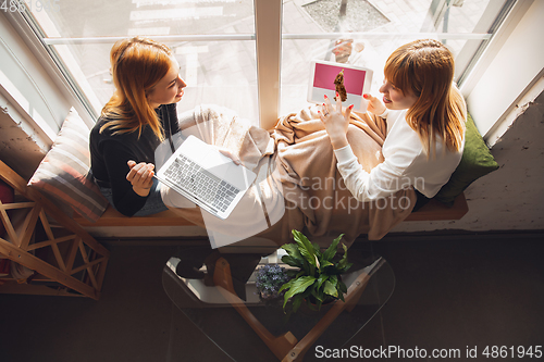 Image of Young friends, women using gadgets to watch cinema, photos, online courses, taking selfie or vlog