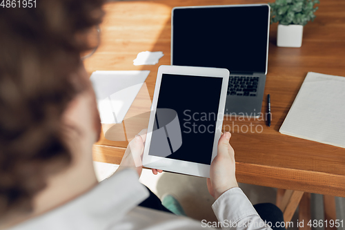 Image of Caucasian young man in business attire working in office, job, online studying