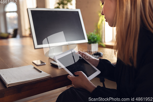 Image of Caucasian young woman in business attire working in office