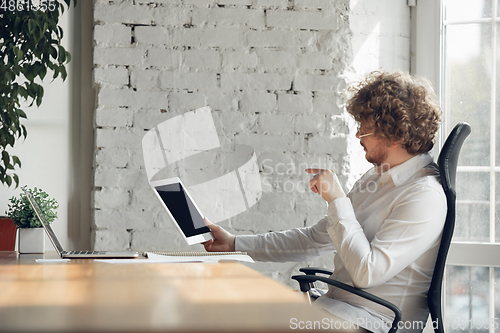 Image of Caucasian young man in business attire working in office, job, online studying