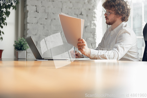 Image of Caucasian young man in business attire working in office, job, online studying