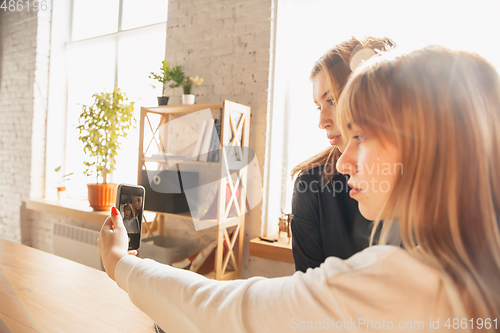 Image of Young friends, women using gadgets to watch cinema, photos, online courses, taking selfie or vlog