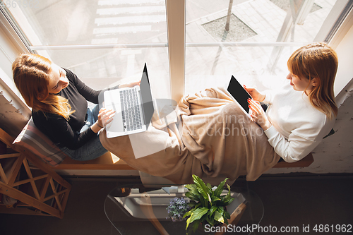 Image of Young friends, women using gadgets to watch cinema, photos, online courses, taking selfie or vlog