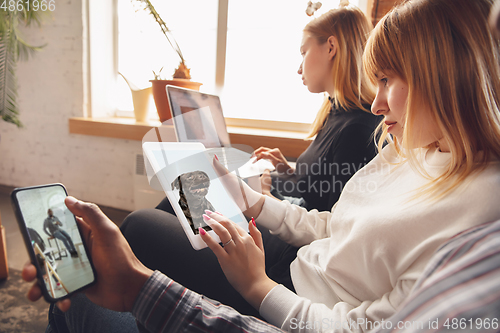 Image of Young friends, women using gadgets to watch cinema, photos, online courses, taking selfie or vlog