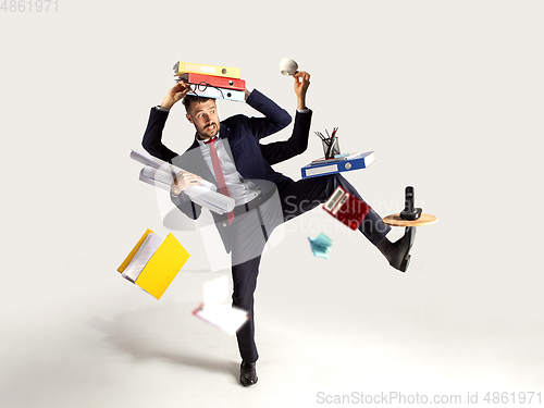 Image of Young caucasian businessman, manager who manages everything, a lot of things and deals