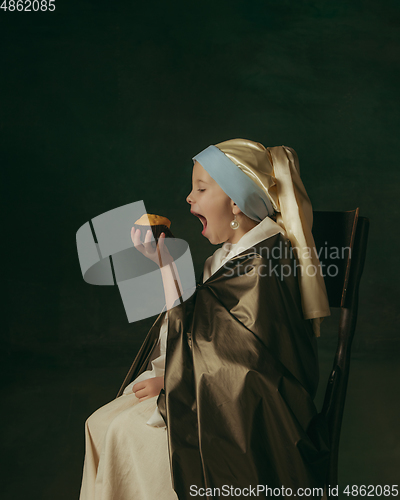 Image of Medieval little girl as a lady with a pearl earring on dark studio background. Concept of comparison of eras, childhood. Stylish creative design, art vision, new look of artwork.