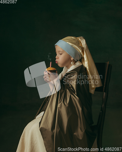 Image of Medieval little girl as a lady with a pearl earring on dark studio background. Concept of comparison of eras, childhood. Stylish creative design, art vision, new look of artwork.