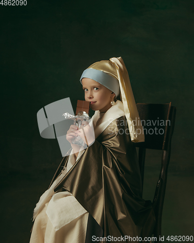 Image of Medieval little girl as a lady with a pearl earring on dark studio background. Concept of comparison of eras, childhood. Stylish creative design, art vision, new look of artwork.