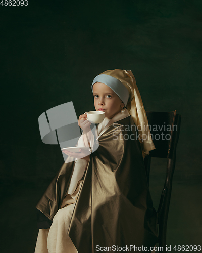 Image of Medieval little girl as a lady with a pearl earring on dark studio background. Concept of comparison of eras, childhood. Stylish creative design, art vision, new look of artwork.