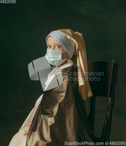 Image of Medieval little girl as a lady with a pearl earring on dark studio background. Concept of comparison of eras, childhood. Stylish creative design, art vision, new look of artwork.