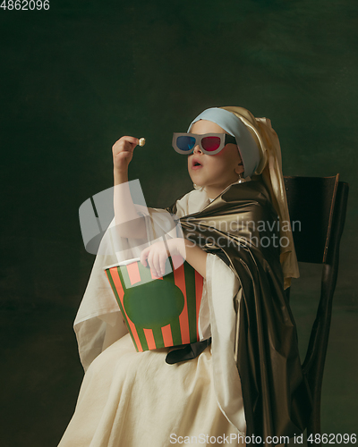 Image of Medieval little girl as a lady with a pearl earring on dark studio background. Concept of comparison of eras, childhood. Stylish creative design, art vision, new look of artwork.