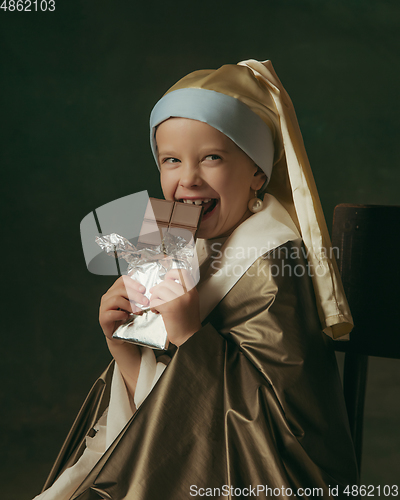 Image of Medieval little girl as a lady with a pearl earring on dark studio background. Concept of comparison of eras, childhood. Stylish creative design, art vision, new look of artwork.