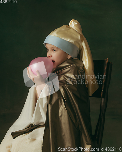 Image of Medieval little girl as a lady with a pearl earring on dark studio background. Concept of comparison of eras, childhood. Stylish creative design, art vision, new look of artwork.