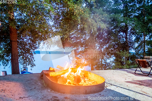 Image of camping bon fire by the lake