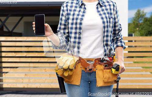 Image of woman or builder with phone and working tools