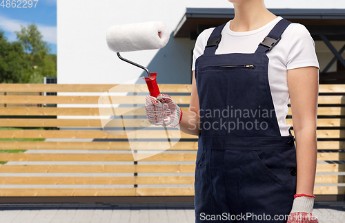 Image of close up of painter or builder with paint roller