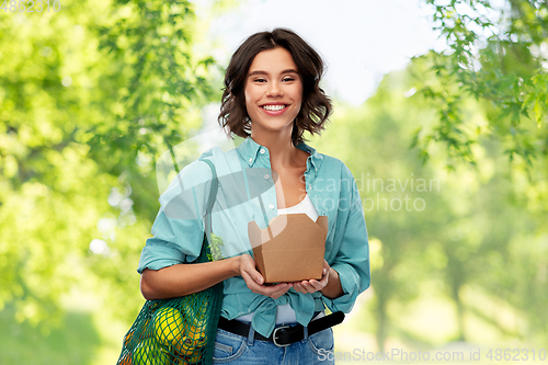 Image of happy woman with food in reusable net bag and wok