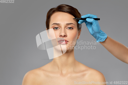 Image of beautiful young woman and hand with marker