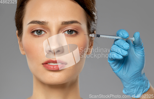 Image of beautiful young woman and hand with syringe