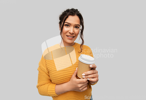 Image of smiling woman with pierced nose holding coffee cup