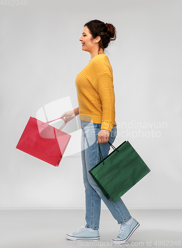 Image of happy smiling young woman with shopping bags