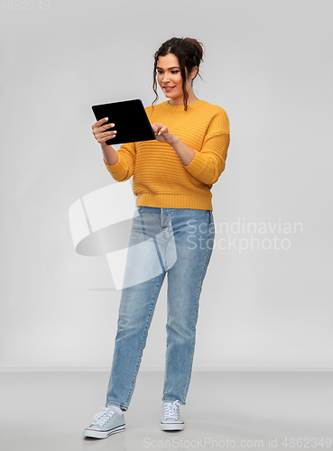 Image of happy young woman using tablet pc computer