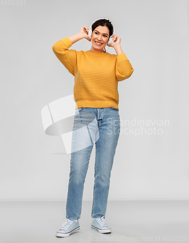 Image of happy woman in headphones listening to music