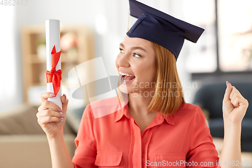 Image of student woman with laptop and diploma at home