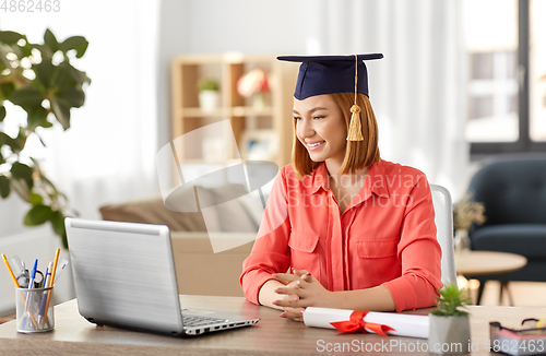 Image of student woman with laptop and diploma at home