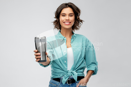 Image of woman with thermo cup or tumbler for hot drinks