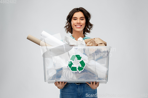 Image of happy smiling young woman sorting paper waste