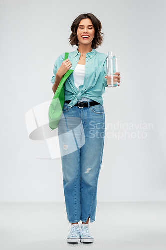 Image of woman with bag for food shopping and glass bottle