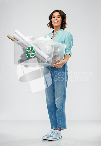Image of happy smiling young woman sorting paper waste