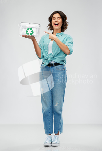 Image of smiling young woman sorting metallic waste