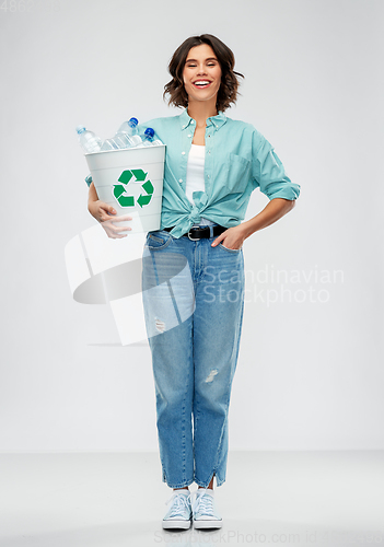 Image of smiling young woman sorting plastic waste