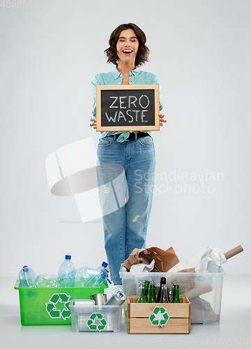 Image of happy woman sorting paper, metal and plastic waste