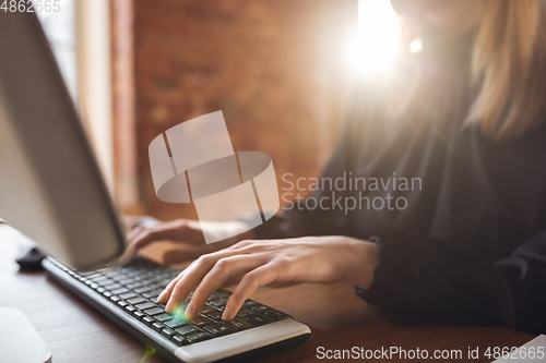 Image of Caucasian young woman in business attire working in office