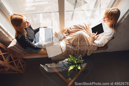 Image of Young friends, women using gadgets to watch cinema, photos, online courses, taking selfie or vlog