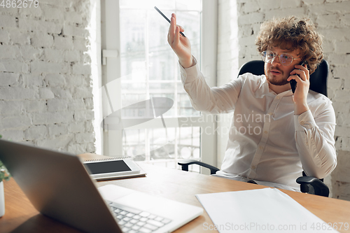 Image of Caucasian young man in business attire working in office, job, online studying