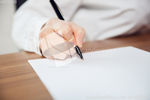 Image of Caucasian young woman in business attire working in office