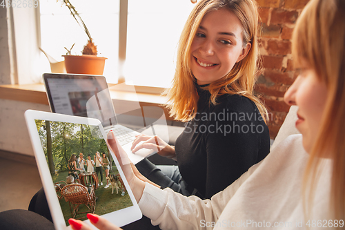 Image of Young friends, women using gadgets to watch cinema, photos, online courses, taking selfie or vlog