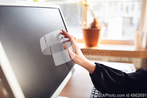 Image of Caucasian young woman in business attire working in office