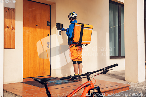 Image of Contacless delivery service during quarantine. Man delivers food and shopping bags during isolation