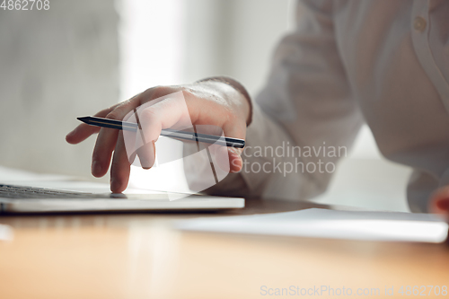 Image of Caucasian young man in business attire working in office, job, online studying