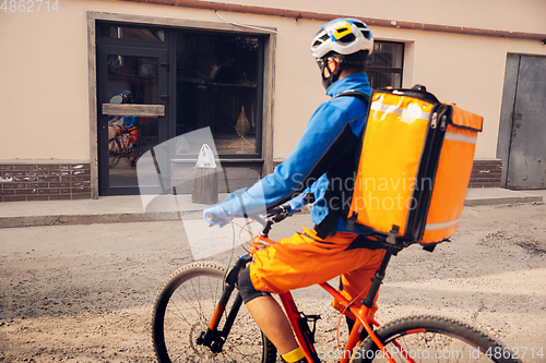 Image of Contacless delivery service during quarantine. Man delivers food and shopping bags during isolation